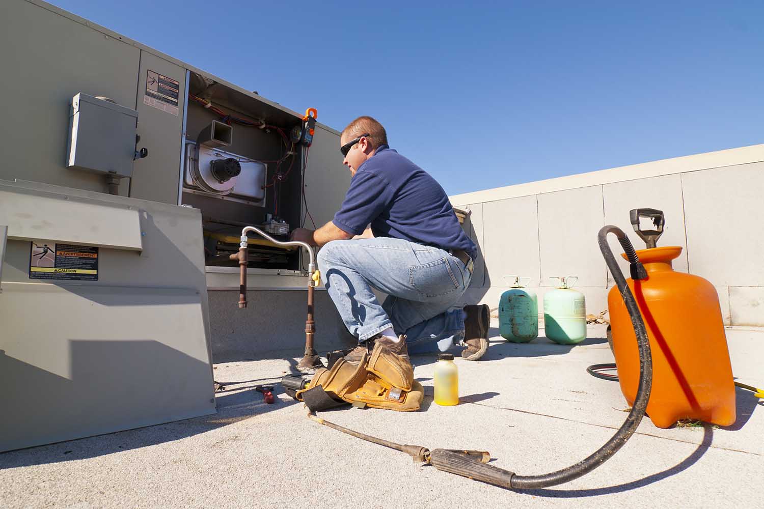 HVAC technician performing maintenance